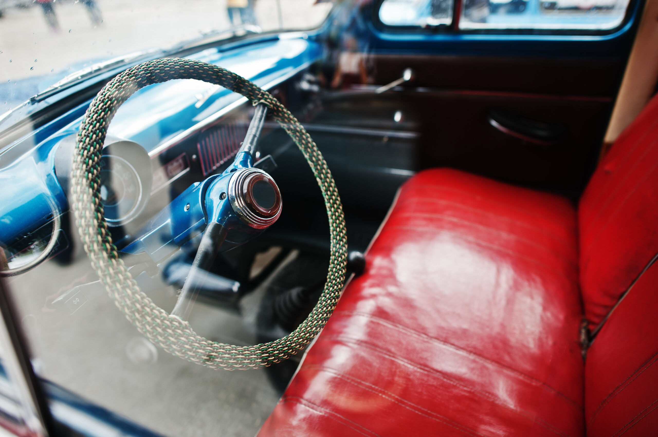 Interior and steering wheel with red leather seats on old vintag